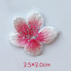 Front-facing pink cherry blossom embroidered patch with white petal tips and silver-tone stamens
