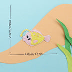 pink anglerfish embroidered stick-on patch — round spotted fish with glowing lure