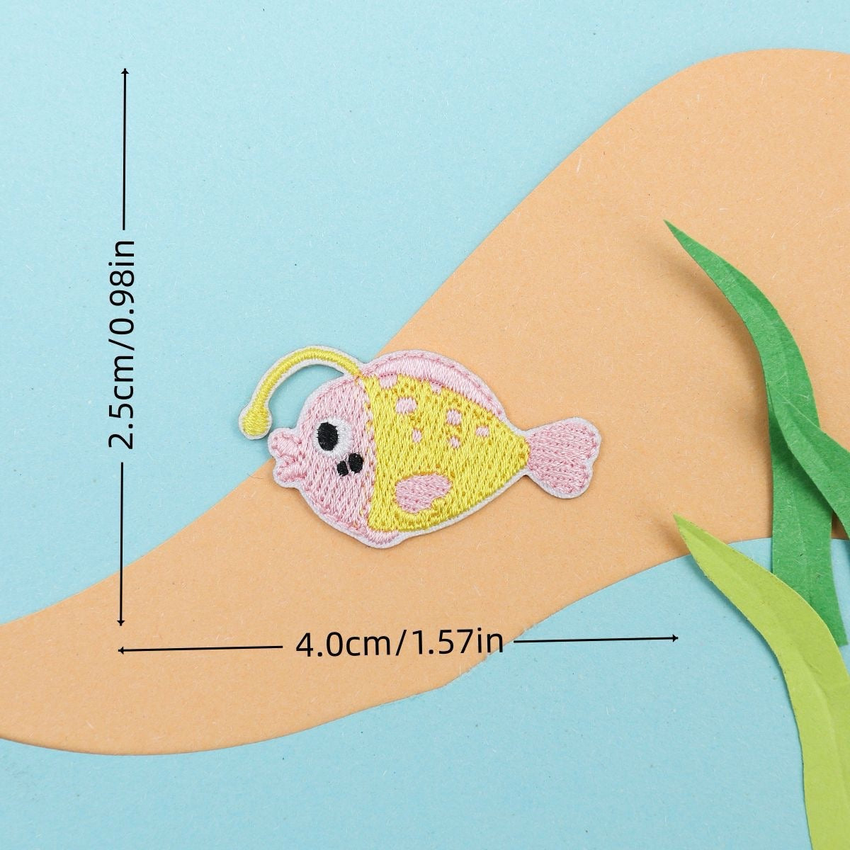 pink anglerfish embroidered stick-on patch — round spotted fish with glowing lure