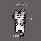 Helpless gray tabby cat embroidered stick-on patch with dangling paws and striped tail
