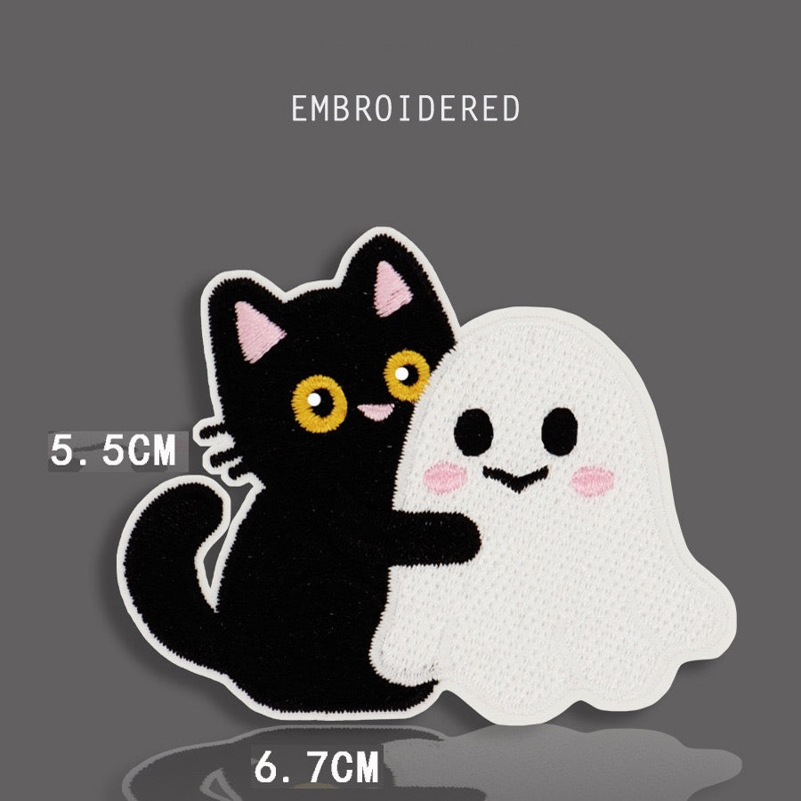 black cat hugging ghost embroidered stick-on patch — black cat with yellow eyes arms around white kawaii ghost with pink blush cheeks