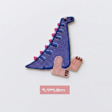 purple Spinosaurus kawaii embroidered stick-on patch — tall slim purple dinosaur with colorful dorsal fin long neck and gentle expression