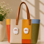 large and small fluffy white alpaca with pink cheeks stick-on patches decorating a multicolor stripe leather handbag