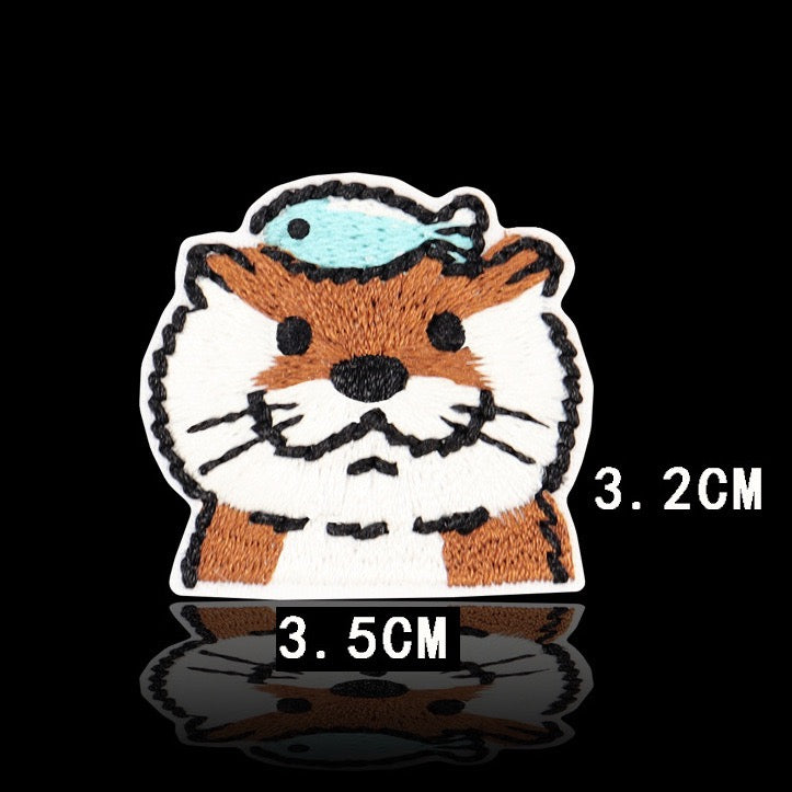 otter head with blue fish balanced on top embroidered patch