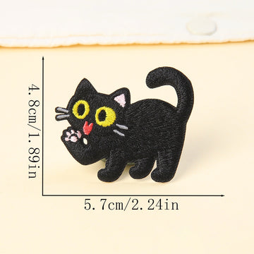 paw licking black cat embroidered stick-on patch — raised paw with pink tongue