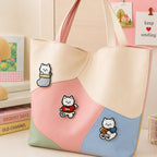 white westie in knit sock red sweater and holding coffee cup stick-on patches decorating a pink blue and mint color-block leather handbag