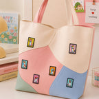 shiba corgi hound beagle terrier and bulldog in bold color pop art frames stick-on patches decorating a pink and cream wave color-block leather handbag