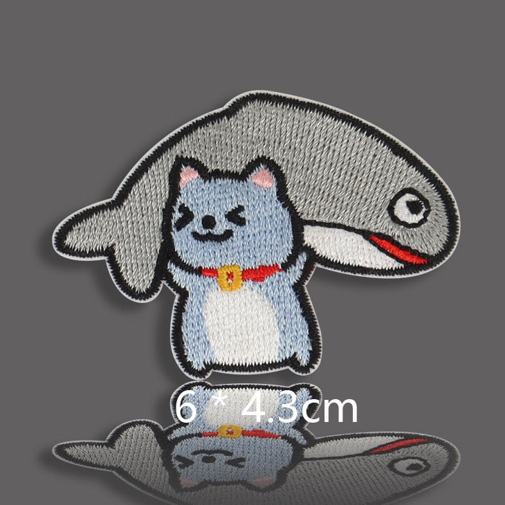 blue gray cat buried under big fish with red collar embroidered patch