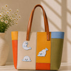 fluffy white baby seal in sitting lying and rolling poses stick-on patches decorating a multicolor stripe leather handbag