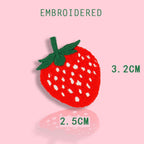 small red strawberry embroidered stick-on patch — vivid red embroidery with white seed dots and green leaf top compact accent size 25x32mm