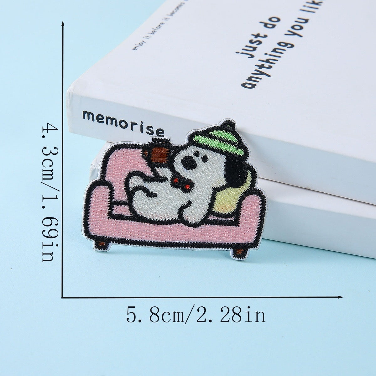 dog relaxing on pink sofa with green beanie embroidered stick-on patch
