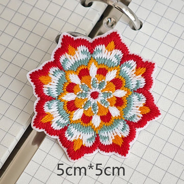 Eight-point floral embroidered stick-on patch with red and white petals

