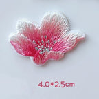 Side-view pink cherry blossom embroidered patch with upward-curving petals and silver-tone stamens

