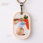 holding a carrot storybook bunny double-sided embroidered keychain charm