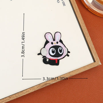 Black cat embroidered stick-on patch wearing a white bunny hood with pink-lined ears
