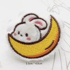 white bunny on crescent moon embroidered stick-on patch — bunny tucked inside yellow moon curve half-submerged looking out dreamlike