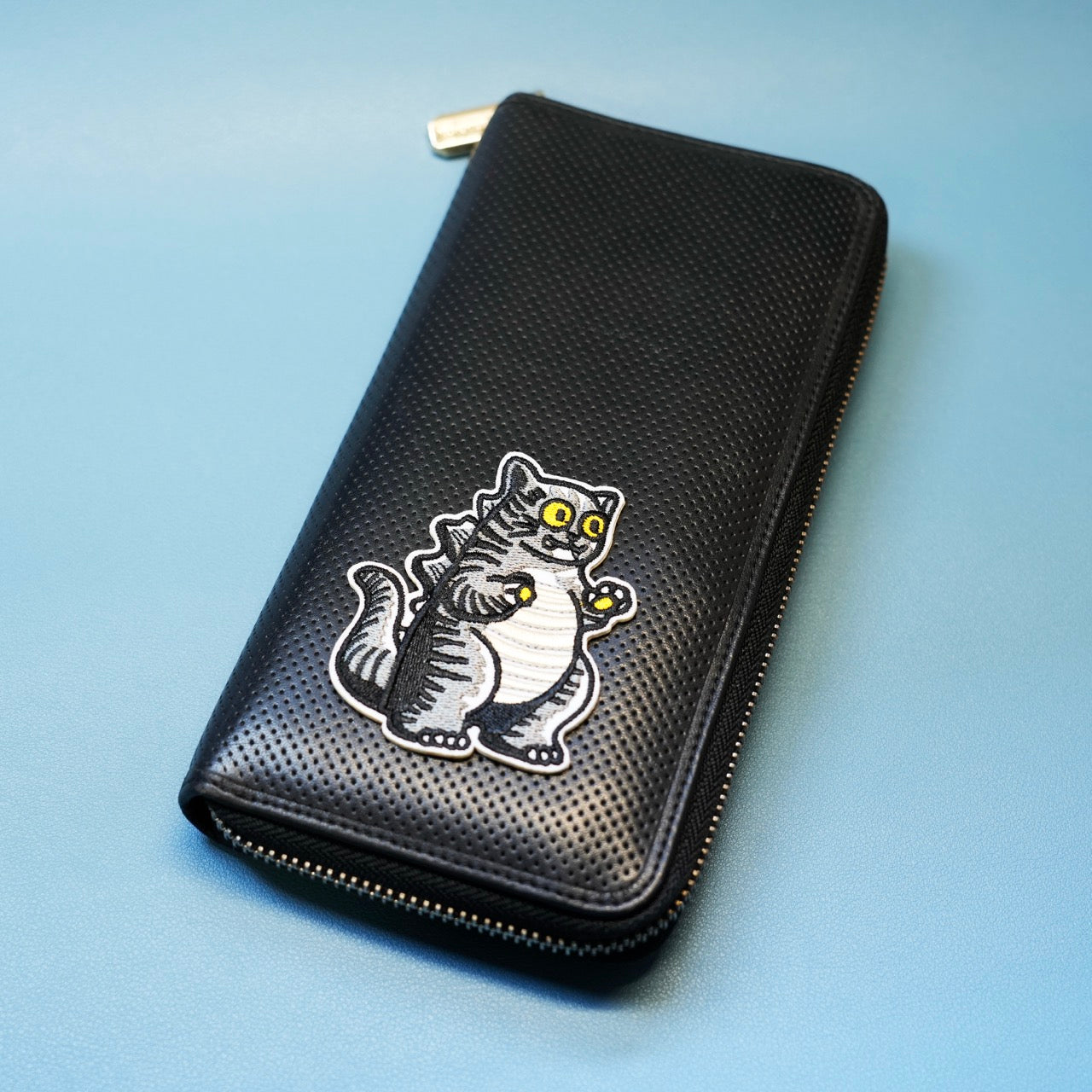 cat godzilla patch sticker on a wallet