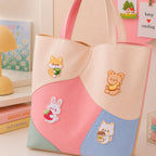 shiba inu bear bunny and cat holding tea banana strawberry and boba stick-on patches decorating a pink and cream wave color-block leather handbag