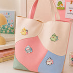 chubby chick bunny astronaut dinosaur and headphone elf stick-on patches decorating a pink and cream wave color-block leather handbag