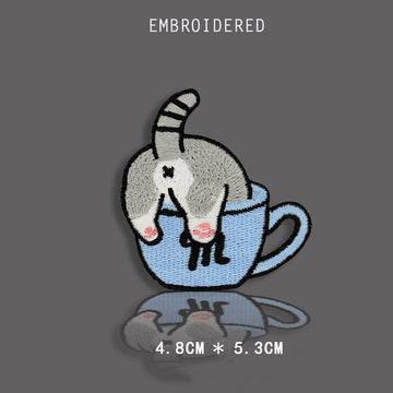 tabby cat diving headfirst into a cup embroidered stick-on patch