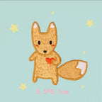 Golden-orange fox embroidered patch holding a red heart with a large white-tipped tail

