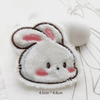 white bunny head embroidered stick-on patch — close-up round white bunny face ears up soft fluffy velvety texture
