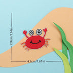 red crab embroidered stick-on patch — smiling face with googly eyes and raised claws