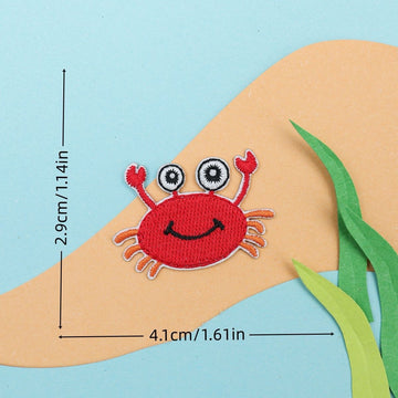red crab embroidered stick-on patch — smiling face with googly eyes and raised claws