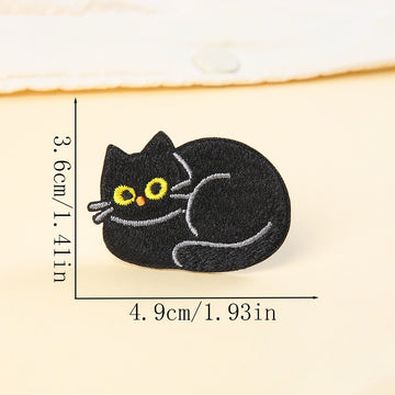 curled up loafing black cat embroidered stick-on patch — tucked into itself