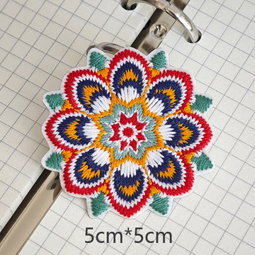 Eight-petal floral embroidered stick-on patch with feather-like navy patterns

