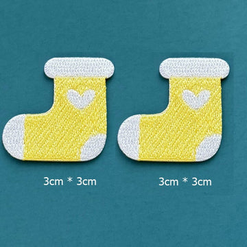 yellow heart stocking embroidered stick-on patches — pair of bright yellow stockings with white cuff white heart motif and white toe 30x30mm