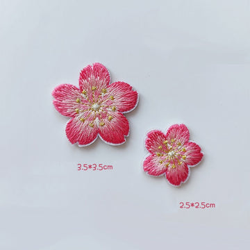 Matching cherry blossom patches with deep pink petal edges, pale centers, and gold-tone stamens
