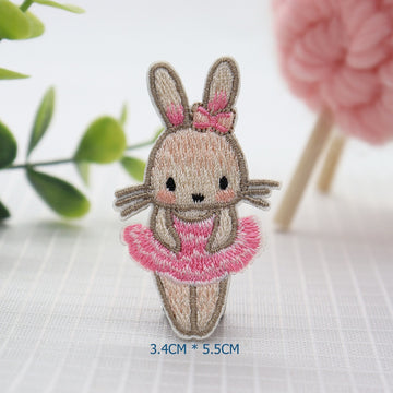 Ballerina bunny embroidered patch wearing a pink tutu and matching bow between upright ears

