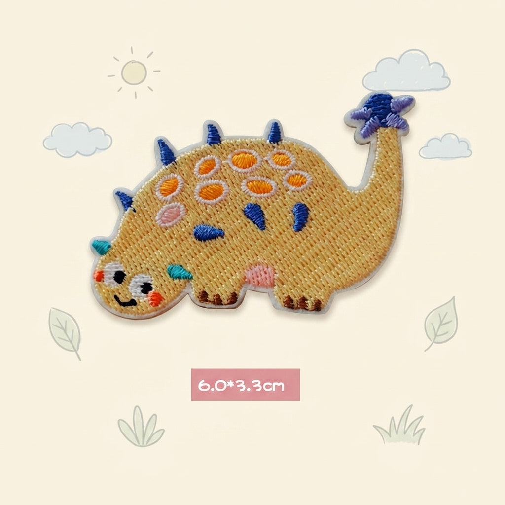 yellow Ankylosaurus kawaii embroidered stick-on patch — low wide yellow ankylosaur covered in round colorful armor plates tail curled upward