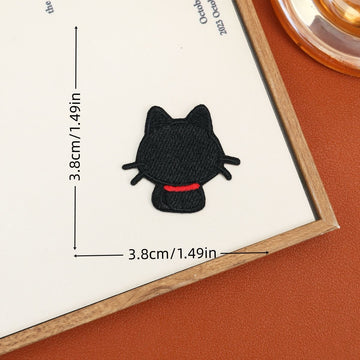 Back-view black cat embroidered stick-on patch with pointed ears and a red scarf
