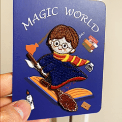 animated hand holding packaged magic world embroidered patches showing three styles and detailed embroidery texture
