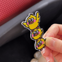animated peel and stick demo of triple stacked ducks quirky embroidered patch applied to car center console