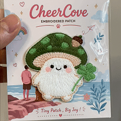animated hand holding packaged cute four seasons mushroom baby embroidered patches showing detailed embroidery texture