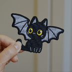 animated close-up of Halloween black cat embroidered patch texture and stitching detail