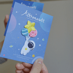 peeling and applying a kawaii astronaut embroidered stick-on patch — texture and stitching close-up