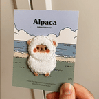 animated hand holding packaged alpaca embroidered patches showing detailed embroidery texture