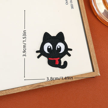 Curious black cat embroidered stick-on patch with sideways-looking eyes and a curled tail
