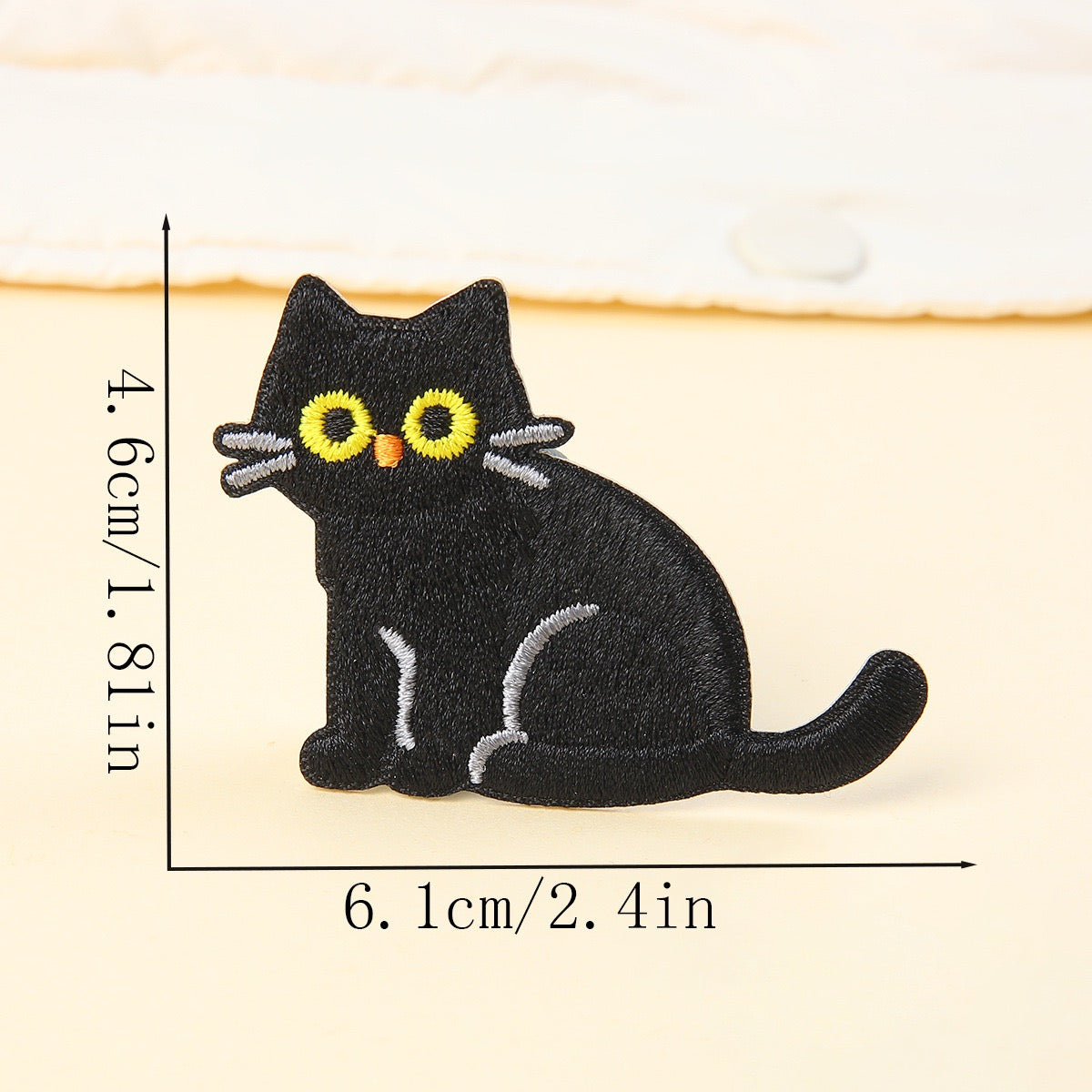 side sitting black cat embroidered stick-on patch — tail curled around feet