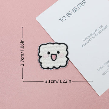 White cloud embroidered stick-on patch with a scalloped outline and an open smile
