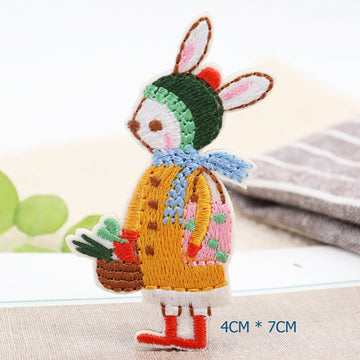 Winter bunny embroidered patch with a green hat, blue scarf, red boots, and vegetable basket
