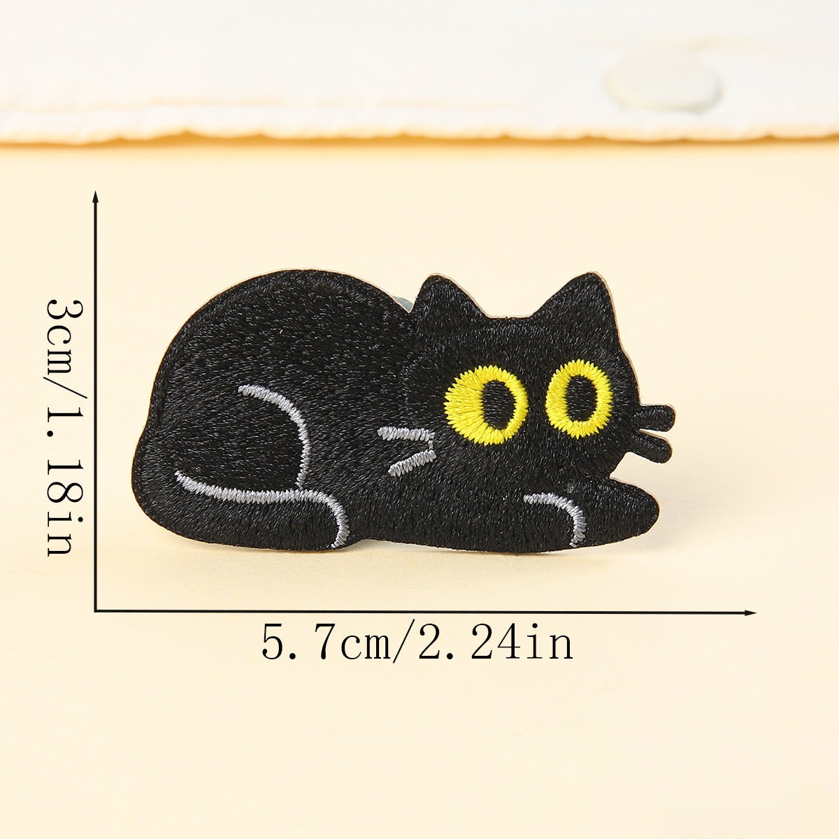 lying down flat black cat embroidered stick-on patch — chin on ground