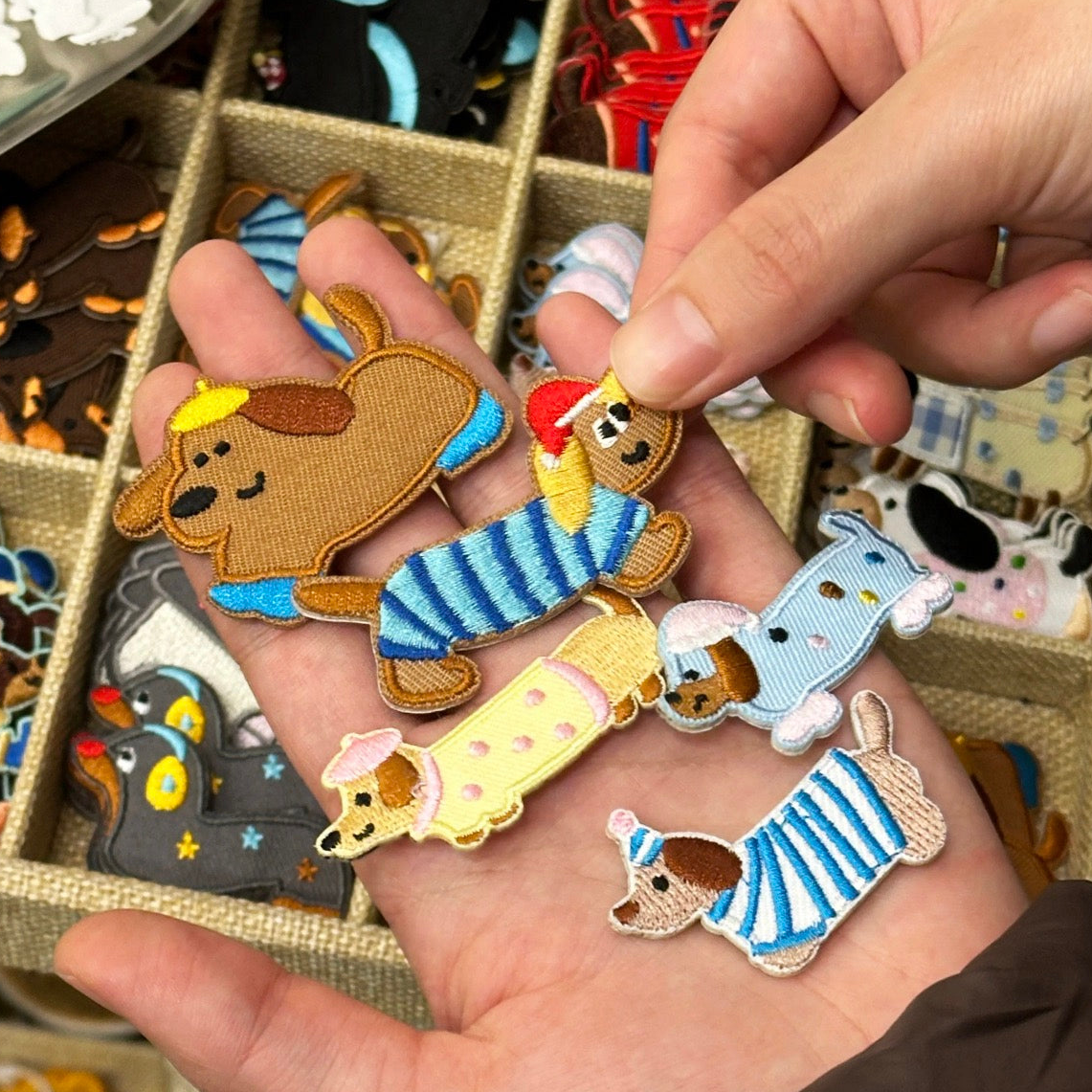 french beret wiener dog stick-on embroidered patches held in hand