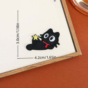 Reclining black cat embroidered stick-on patch with a red scarf and small yellow star
