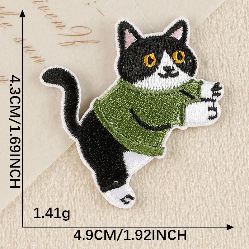 sporty tuxedo cat in olive hoodie whimsical embroidered stick-on patch