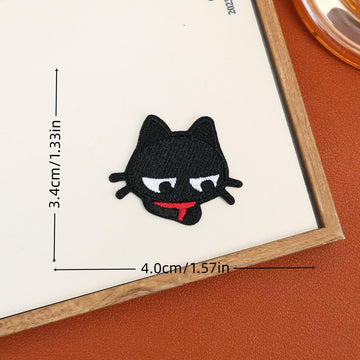 Sleepy black cat embroidered stick-on patch with half-lidded eyes and a red scarf
